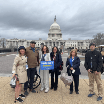 Group of people standing in front of the U.S. Capitol