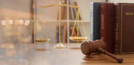books for lawyers sitting on a desk with a gavel