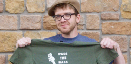 Dylan Flynn posing with Pass The Bass Merch