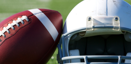 A helmet and football in a field for a story about Tua Tagovailoa's Concussion