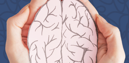 A pair of hands holding an illustration of a brain