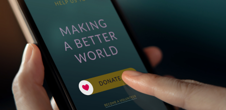 person making a donation online on a phone
