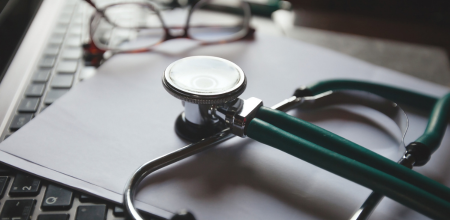 stethoscope and glasses on a computer